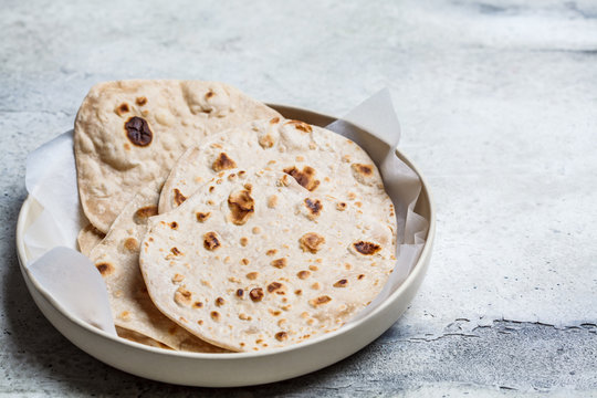 Homemade indian flatbread chapati on a gray background. Vegetarian cuisine concept.