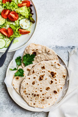 Homemade indian flatbread chapati on a gray background. Vegetarian cuisine concept.