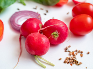 Radish with fresh vegetables on white background top view. Close-up