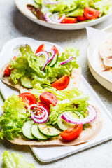 Homemade flatbread with fresh vegetables. Healthy vegan food concept.