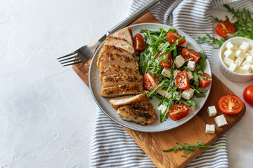 Close-up on a salad with chicken and tomato