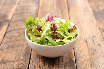 bowl of lettuce on wood background