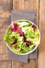 bowl of lettuce on wood background