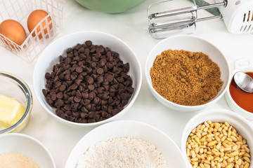Chocolate chips and ingredients for baking needs close up on a kitchen table. Chocolate Chip Cookies recipe