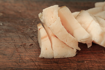 Slices of bacon on a wooden board