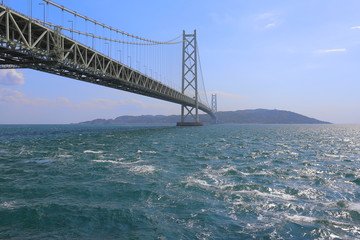 巨大なつり橋と風で荒れる海