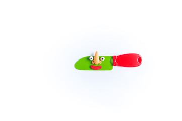 Toy dishes with eyes and mouth of plasticine. Conceptual photo.