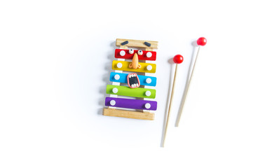 Xylophone toy with eyes and mouth of plasticine. Conceptual photo.