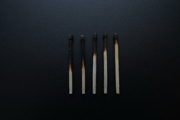burnt matches on a black background close up