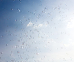 Soap bubbles fly in the blue sky