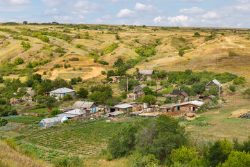 An old traditional poor russian village on a hillside