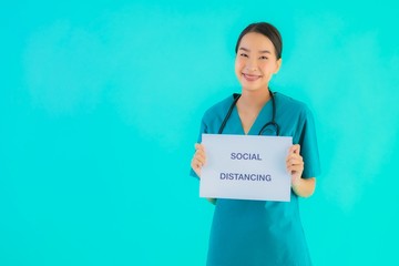 Portrait beautiful young asian doctor woman show sign with Social distancing