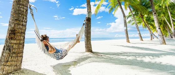 Foto op Plexiglas Man in hammock on the beautiful tropical beach. Banner. © upslim