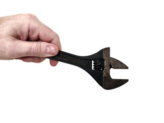 Old adjustable wrench in hand isolated on white background.  Selective focus. 