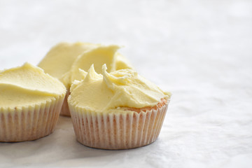 Muffin on parchment paper with copy space on the right side.  Homemade cupcake.  Selective and soft focus. 