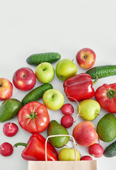 Paper bag with different vegetables isolated on white background.