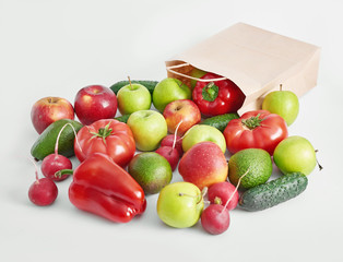 Paper bag with different vegetables isolated on white background.
