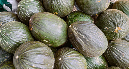Fototapeta na wymiar Frog skin melons for sale in fresh produce shelves in supermarket