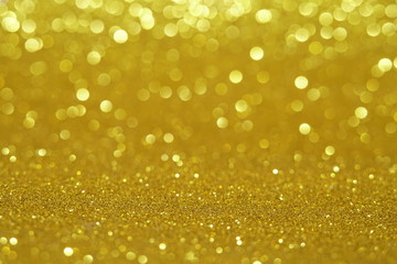 gold Sparkling Lights Festive background with texture. Abstract Christmas twinkled bright bokeh defocused and Falling stars. Winter Card or invitation	
