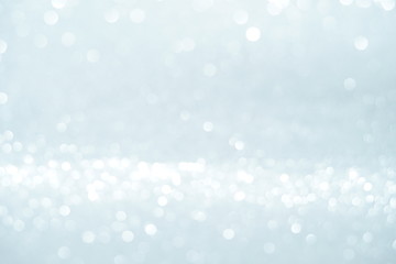 Silver Sparkling Lights Festive background with texture. Abstract Christmas twinkled bright bokeh defocused and Falling stars. Winter Card or invitation	