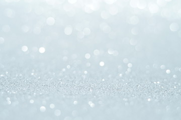 Silver Sparkling Lights Festive background with texture. Abstract Christmas twinkled bright bokeh defocused and Falling stars. Winter Card or invitation	