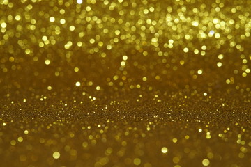 gold Sparkling Lights Festive background with texture. Abstract Christmas twinkled bright bokeh defocused and Falling stars. Winter Card or invitation	