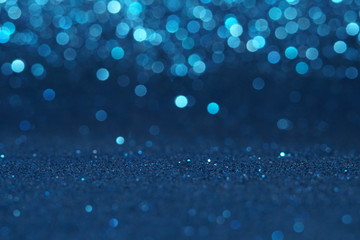 blue Sparkling Lights Festive background with texture. Abstract Christmas twinkled bright bokeh defocused and Falling stars. Winter Card or invitation	