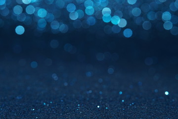 blue Sparkling Lights Festive background with texture. Abstract Christmas twinkled bright bokeh...