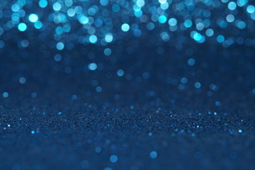 blue Sparkling Lights Festive background with texture. Abstract Christmas twinkled bright bokeh defocused and Falling stars. Winter Card or invitation	