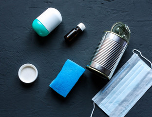 Recycling garbage is scattered on a dark surface. 