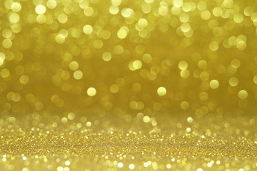 gold Sparkling Lights Festive background with texture. Abstract Christmas twinkled bright bokeh...