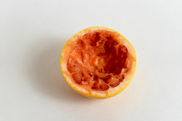 sliced and squeezed grapefruit on a chopping board