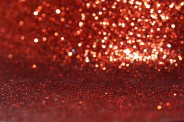 red Sparkling Lights Festive background with texture. Abstract Christmas twinkled bright bokeh defocused and Falling stars. Winter Card or invitation	