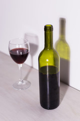 Shadow of wine glass in dark light.