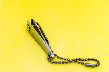 Nail clippers on yellow background, metal nail cutter, tool to trim fingernails - Image