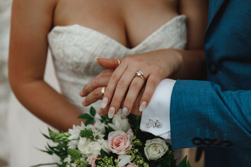 Engagement rings .The girl and the boy put their hands . Bride and groom with Engagement gold rings put their hands
