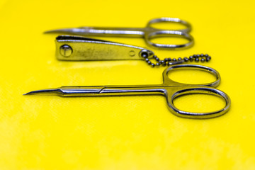 Set of manicure tools, manicure and pedicure instruments on yellow background, nail clippers and scissors - Image