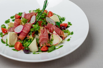 Salad with vegetables cheese and meat pesto sauce