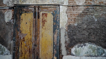 Iron fence ornaments and wooden doors in ancient Roman style buildings.