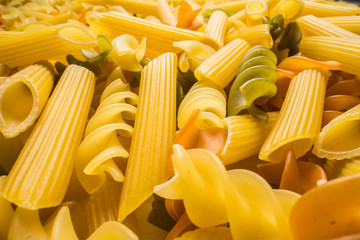 Variety of types and shapes of dry Italian pasta close-up. Food and traditional cuisine.