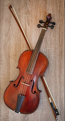 Fototapeta na wymiar Violin on a wooden background . Violin and bow. 
