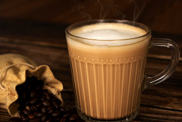 Hot latte coffee on the wooden table surface