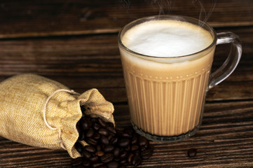 Hot latte coffee on the wooden table surface