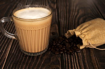 Hot latte coffee on the wooden table surface