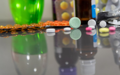 Pills and medicines on a dark mirrored background