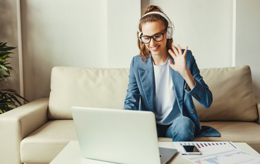 Professional woman having video conversation on laptop.