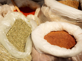 Sale of friable cereals and seasonings in open bags on a bazaar counter. Trade in cereals and...