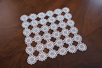 lace hand-knitted. lace tablecloth. Patterns knitted with lace crochet. Lace hand-knitted on wooden...