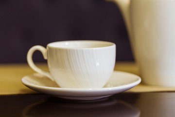 Tea cup and tea pot on table. Breakfast and Five O'Clock Tea. Tea time.