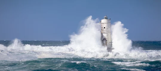 Foto op Canvas The lighthouse of the boat-eater shrouded by the waves of a mistral wind storm © ivan canavera